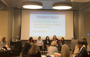FY_StudentPanel_09-27-19 Five student panelists sit at the front of a conference room and field questions from the conference participants.
