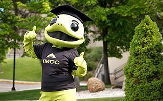 Wizard, the lizard mascot for TMCC, gives a double thumbs-up