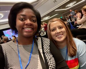 2022 Blueprint Conference_Toni & Laura Toni Duncan and Laura Obrist pose for a selfie inside a conference ball room