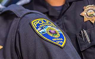 A closeup of a Nevada University Police patch worn on the shoulder of a law enforcement officer