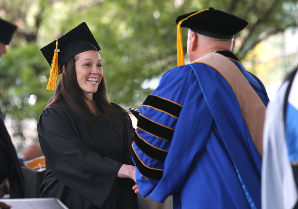 President Chet Burton congratulates graduates during the 45th annual Western Nevada College Commencement ceremony