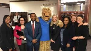 Assembly members Monroe-Moreno, Cohen, McCurdy II, Krasner, Miller, Bilbray-Axelrod and Benitez-Thompson with the WNC Wildcat.
