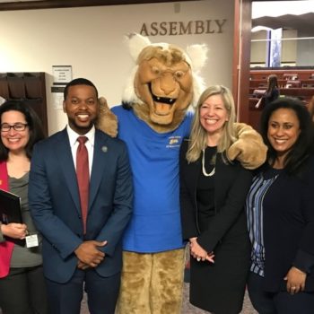 Assembly members Monroe-Moreno, Cohen, McCurdy II, Krasner, Miller, Bilbray-Axelrod and Benitez-Thompson with the WNC Wildcat.