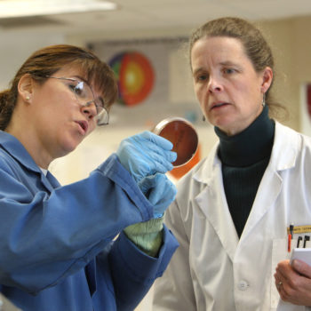 An instructor talks with a student during a biology class at WNC